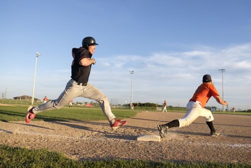 ZACHARY PRONG / WINNIPEG FREE PRESS  Cole Paquin of the Winnipeg South Chiefs runs into first base. To his left, Mack Hamm of the Pembina Valley Orioles. July 27, 2016.