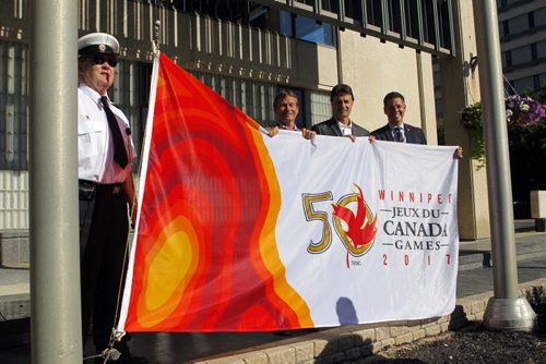 BORIS MINKEVICH / WINNIPEG FREE PRESS Canada Games flag being raised at city hall. L-R Corp Commissionaires Bill Durward, 2017 Canada Games co-chair Hubert Mesman, 2017 Canada Games president & CEO Jeff Hnatiuk, Winnipeg Mayor Brian Bowman. They pose with the flag. July 28, 2016