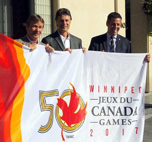 BORIS MINKEVICH / WINNIPEG FREE PRESS Canada Games flag being raised at city hall. L-R 2017 Canada Games co-chair Hubert Mesman, 2017 Canada Games president & CEO Jeff Hnatiuk, Winnipeg Mayor Brian Bowman. They pose with the flag. July 28, 2016