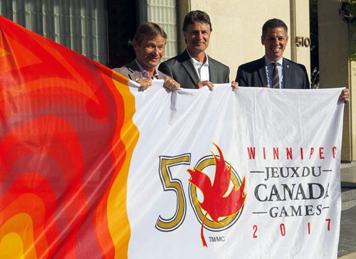 BORIS MINKEVICH / WINNIPEG FREE PRESS Canada Games flag being raised at city hall. L-R 2017 Canada Games co-chair Hubert Mesman, 2017 Canada Games president & CEO Jeff Hnatiuk, Winnipeg Mayor Brian Bowman. They pose with the flag. July 28, 2016