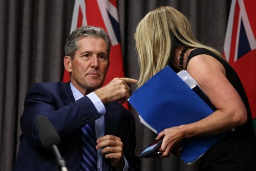 MIKE DEAL / WINNIPEG FREE PRESS  Premier Brian Pallister has a brief discussion with press secretary Olivia Baldwin-Valainis while answering  questions regarding the Port of Churchill. He expressed great frustration over a non-disclosure agreement the previous government signed with Omnitrax.   160728 Thursday, July 28, 2016