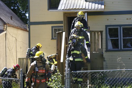 WAYNE GLOWACKI / WINNIPEG FREE PRESS  Winnipeg Fire Fighters extinguish a fire at the back of a house in the 400 block of Pritchard Ave. near Andrews St. Thursday. No one was home when the fire broke out. July 28 2016