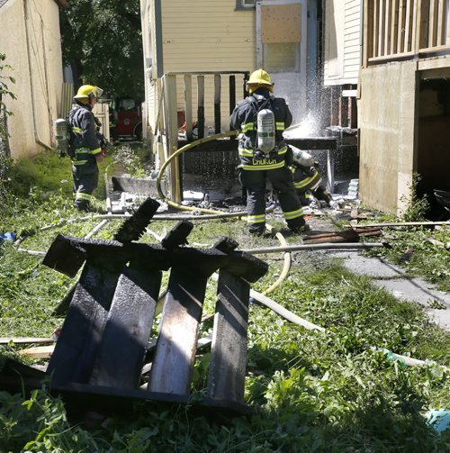 WAYNE GLOWACKI / WINNIPEG FREE PRESS  Winnipeg Fire Fighters extinguish a fire at the back of a house in the 400 block of Pritchard Ave. near Andrews St. Thursday.  No one was home when the fire broke out. July 28 2016