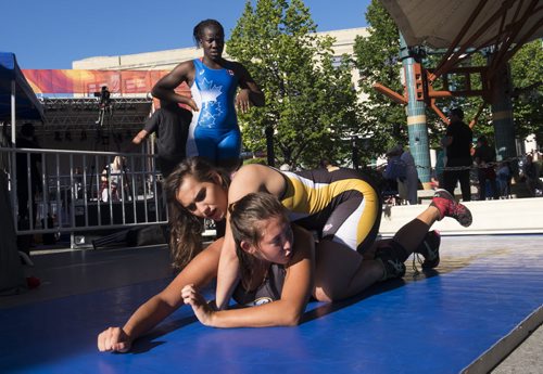 ZACHARY PRONG / WINNIPEG FREE PRESS  Jayden Ramgotra, top, and Jessica Popowich, wrestlers from Winnipeg who hope to compete in the Canada Summer Games in 2017, perform practice drills at The Forks. Athletes ran interactive kiosks demonstrating some of the sports that be presented at the Canada Summer Games. July 28, 2016.