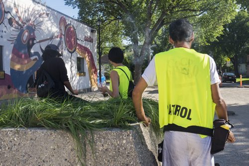 ZACHARY PRONG / WINNIPEG FREE PRESS Members of the Bear Clan Patrol, a group of volunteers who patrols the North End most evenings of the week to prevent violence, meets at the park before they head out. From left to right, Jordan Harper, Amanda Roesler and Waylon Flett. July 29, 2016.