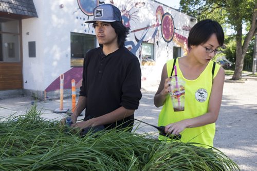 ZACHARY PRONG / WINNIPEG FREE PRESS Members of the Bear Clan Patrol, a group of volunteers who patrols the North End most evenings of the week to prevent violence, meets at the park before they head out. From left to right, Jordan Harper and Amanda Roesler. July 29, 2016.