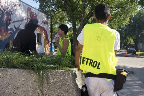 ZACHARY PRONG / WINNIPEG FREE PRESS  Members of the Bear Clan Patrol, a group of volunteers who patrols the North End most evenings of the week to prevent violence, meets at the park before they head out.  From left to right, Jordan Harper, Amanda Roesler and Waylon Flett. July 29, 2016.