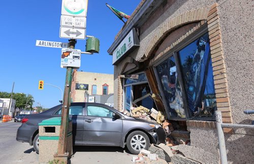TREVOR HAGAN / WINNIPEG FREE PRESS A two vehicle collision sent one car into the front of The Club at the corner of Sargent and Arlington, Saturday, July 30, 2016.