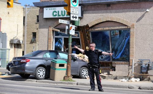 TREVOR HAGAN / WINNIPEG FREE PRESS A two vehicle collision sent one car into the front of The Club at the corner of Sargent and Arlington, Saturday, July 30, 2016.