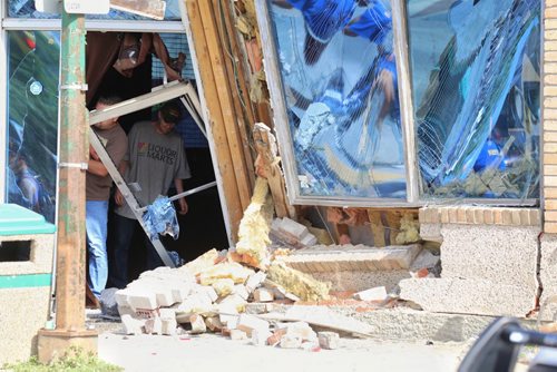 TREVOR HAGAN / WINNIPEG FREE PRESS A two vehicle collision sent one car into the front of The Club at the corner of Sargent and Arlington, Saturday, July 30, 2016.