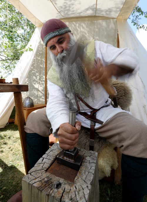 TREVOR HAGAN / WINNIPEG FREE PRESS Christian Arel, from Wetaskiwin, a member of Odin's Ravens, was making coins at the Icelandic Festival in Gimli, Saturday, July 30, 2016.