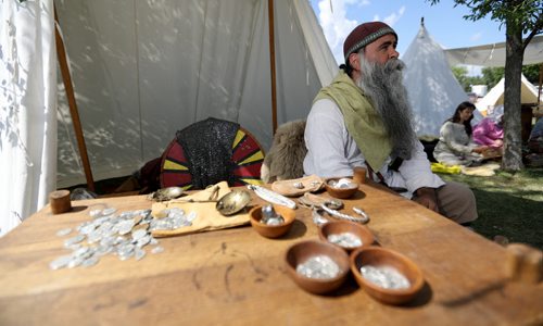 TREVOR HAGAN / WINNIPEG FREE PRESS Christian Arel, from Wetaskiwin, a member of Odin's Ravens, was making coins at the Icelandic Festival in Gimli, Saturday, July 30, 2016.