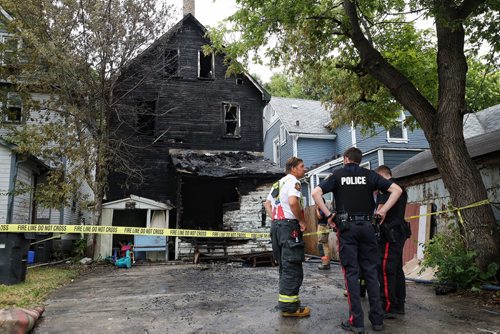 MIKE DEAL / WINNIPEG FREE PRESS  A fire in the 400 block of Victor Street consumed the back porch of a house forcing out twelve occupants, two adults and ten children aged from approximately two to late-teens. No one was injured and the fire was extinguished relatively quickly with damage mostly to the rear of the house.   160801 Monday, August 01, 2016