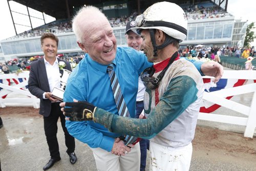 JOHN WOODS / WINNIPEG FREE PRESS Horse owner Randy Howg congratulates Scott Stevens who rode Inside Straight (3) to take home the Manitoba Derby at Assiniboia Downs  Monday, August 1, 2016.