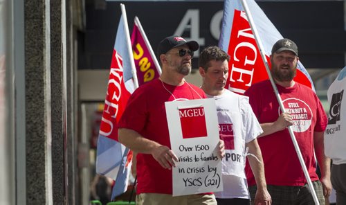 RUTH BONNEVILLE / WINNIPEG FREE PRESS  Employee's with the Macdonald youth service picket along the sidewalk in front of 491 Portage Ave. after going on strike at 10am Tuesday.   Aug 02, 2016  Aug 03, 2016