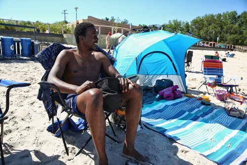 MIKE DEAL / WINNIPEG FREE PRESS  Calvin Moore relaxes with friends and family at Grand Beach the morning after two children drowned.   160802 Tuesday, August 02, 2016