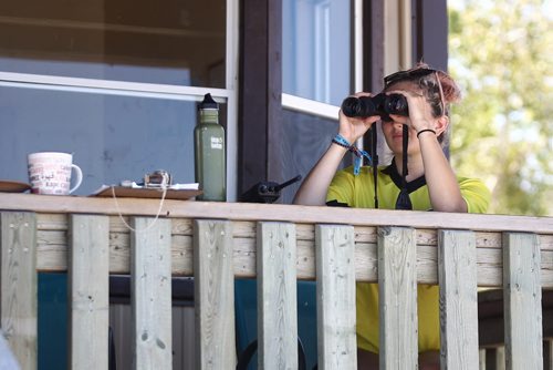 MIKE DEAL / WINNIPEG FREE PRESS  Madison Danyluk, a Beach Safety Officer watches some kids through her binoculars at Grand Beach the morning after two children drowned.   160802 Tuesday, August 02, 2016