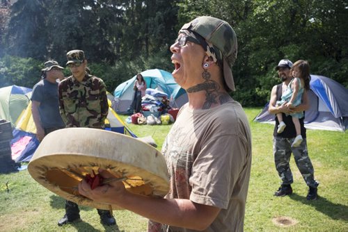 ZACHARY PRONG / WINNIPEG FREE PRESS  Calvin Clarke, a member of the Urban Warrior Alliance, a group of indigenous activists who have been camping out at the Manitoba Legislature Building for the past ten days, celebrates with song after the government announced a national inquiry looking into the the high rate of violence against indigenous women and girls will begin on September 1, 2016. August 3, 2016.