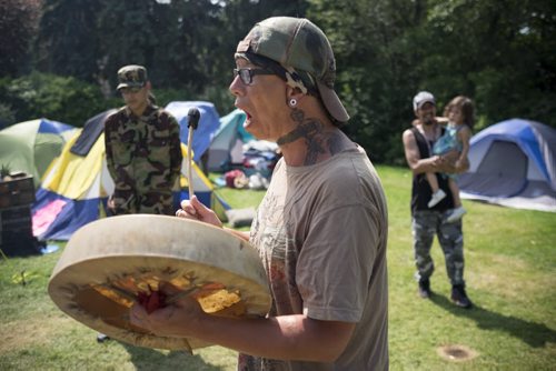 ZACHARY PRONG / WINNIPEG FREE PRESS  Calvin Clarke, a member of the Urban Warrior Alliance, a group of indigenous activists who have been camping out at the Manitoba Legislature Building for the past ten days, celebrates with song after the government announced a national inquiry looking into the the high rate of violence against indigenous women and girls will begin on September 1, 2016. August 3, 2016.