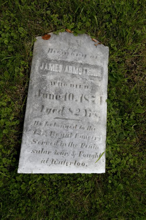 WAYNE GLOWACKI / WINNIPEG FREE PRESS        A weather worn grave marker of James Armstrong lies in the grass of the  St. James Anglican Church cemetery across from Polo Park on Portage Avenue.    Kevin Rollason  story  August 03 2016