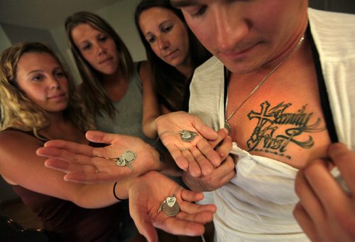 PHIL HOSSACK / WINNIPEG FREE PRESS -   Isaac Babinsky's siblings, left to right - Mackenzie, Krista, Nicole and Jake show tattoos and memorial necklaces, Isaac wrote a high school composition called "Family FIrst" just before he died of an overdose. See Mike MacIntyre's story. August 3, 2016
