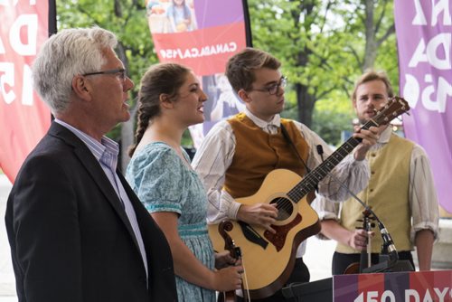 ZACHARY PRONG / WINNIPEG FREE PRESS  Minister of Natural Resources Jim Carr, left, sings O Canada with youth members of of the Folk Ensemble of the Red River at a ceremony marking the countdown to the 150th anniversary of Confederation. From left, Veronique Demers, Joel Rivard and Simon Reimer. August 4, 2016.