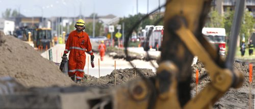 WAYNE GLOWACKI / WINNIPEG FREE PRESS     Manitoba Hydro workers on the scene on Keewatin St. near Paramount Rd. after a road construction crew ripped open a 4 inch natural gas line Thursday morning. Winnipeg Police and Fire Fighters evacuated near by businesses and about 40 homes. August 04 2016