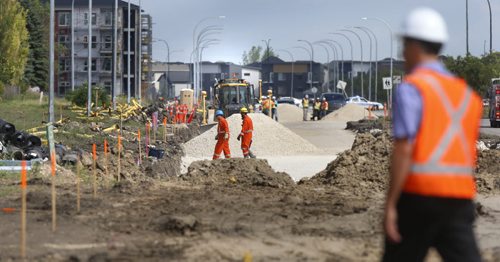 WAYNE GLOWACKI / WINNIPEG FREE PRESS     Manitoba Hydro workers on the scene on Keewatin St. near Paramount Rd. after a road construction crew ripped open a 4 inch natural gas line Thursday morning. Winnipeg Police evacuated near by businesses and about 40 homes. August 04 2016