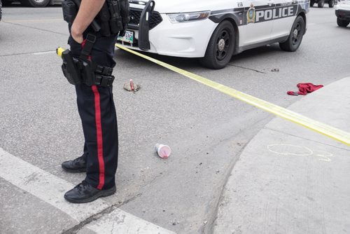 ZACHARY PRONG / WINNIPEG FREE PRESS  Police at the scene of a possible stabbing on Balmoral St. Evidence from the incident is scattered across the road. August 4, 2016.