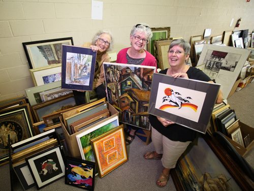 RUTH BONNEVILLE / WINNIPEG FREE PRESS  Volunteers column for the Aug. 8  Grands 'n' More, a local group that raises funds for Stephen Lewis Foundation projects that combat AIDS in Africa are holding a used art sale on 18th of September at Corydon Community Centre to raise funds.  Photo of  Group photo with some of the art for sale - Jean Altemeyer (beige), Judy Cumberford (in black) and Carol Hibbert  Pink). Aug 05, 2016