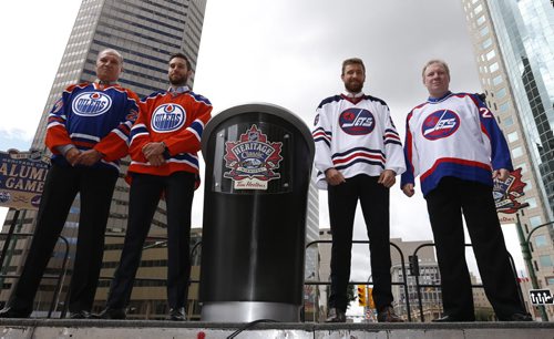 WAYNE GLOWACKI / WINNIPEG FREE PRESS   At the intersection of Portage and Main from left, Edmonton Oilers Alumnus Dave Semenko beside Oilers player Cam Talbot and Winnipeg Jets Blake Wheeler both wearing the Heritage Classic jerseys, and Winnipeg Jets Alumnus Thomas Steen. Heritage Classic jerseys for the Winnipeg Jets and Edmonton Oilers as well as lineups for the respective teams for the accompanying alumni game were unveiled in front of a frenzied audience of a couple hundred  Friday. Tim Campbell story August 5 2016