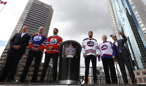 WAYNE GLOWACKI / WINNIPEG FREE PRESS     At the intersection of Portage and Main from left, Edmonton Oilers Alumni Kevin Lowe and Dave Semenko, Edmonton Oilers player Cam Talbot and Winnipeg Jets player Blake Wheeler are wearing the Heritage Classic jerseys beside Winnipeg Jets Alumni Thomas Steen and Dale Hawerchuk   Heritage Classic jerseys for the Winnipeg Jets and Edmonton Oilers as well as lineups for the respective teams for the accompanying alumni game were unveiled in front of a frenzied audience of a couple hundred  Friday. Tim Campbell story August 5 2016