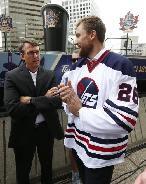 WAYNE GLOWACKI / WINNIPEG FREE PRESS     At the intersection of Portage and Main Winnipeg Jets player Blake Wheeler wearing the Heritage Classic jersey  speaks to Mark Chipman, the Executive Chairman of the Board of True North Sports & Entertainment Limited and Winnipeg Jets Hockey Club at the NHL event Friday. Heritage Classic jerseys for the Winnipeg Jets and Edmonton Oilers as well as lineups for the respective teams for the accompanying alumni game were unveiled in front of a frenzied audience of a couple hundred  Friday. Tim Campbell story August 5 2016