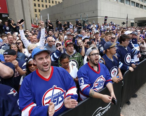 WAYNE GLOWACKI / WINNIPEG FREE PRESS     At the intersection of Portage and Main,  Heritage Classic jerseys for the Winnipeg Jets and Edmonton Oilers as well as lineups for the respective teams for the accompanying alumni game were unveiled in front of a frenzied audience of a couple hundred  Friday. Tim Campbell story August 5 2016