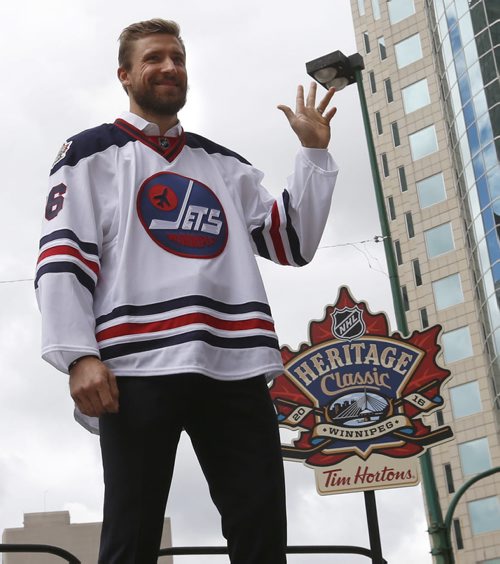 WAYNE GLOWACKI / WINNIPEG FREE PRESS     At the intersection of Portage and Main, Winnipeg Jets player Blake Wheeler wearing the Heritage Classic jersey waves to crowd at the NHL event Friday. Heritage Classic jerseys for the Winnipeg Jets and Edmonton Oilers as well as lineups for the respective teams for the accompanying alumni game were unveiled in front of a frenzied audience of a couple hundred  Friday. Tim Campbell story August 5 2016