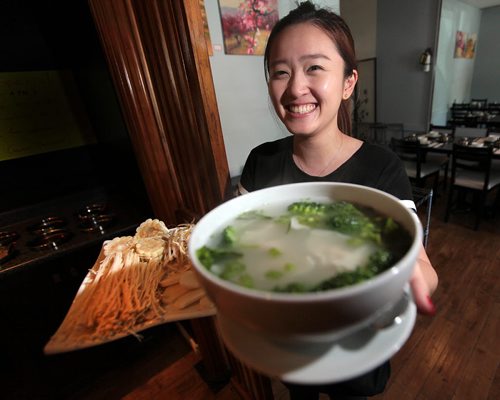 PHIL HOSSACK / WINNIPEG FREE PRESS - Janice Cao shows off a bowl of the Wonton soup at the Asian Hot Pot. See Alison Gilmore's story.  August 5, 2016