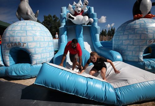 RUTH BONNEVILLE / WINNIPEG FREE PRESS  ZOOOLMYPICS - (standup pix)  Local internationally recognized athletes Obby Khan, Former CFL Football Player and Kaitlyn Lawes, Olympic Gold Medallist, Curling, race against each other through the obstacles in an inflatable at one of the get active stations at the Assiniboine Park Zoo Saturday encouraging visitors  to get active like the athletes in Rio.    Aug 06, 2016