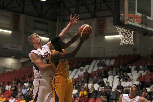 RUTH BONNEVILLE / WINNIPEG FREE PRESS  BC #15 Grant Shepard reaches to grab ball from MB's #8 Emmanual Akot during the National Canada Basketball Championship game at Duckworth Centre Saturday.    Aug 06, 2016