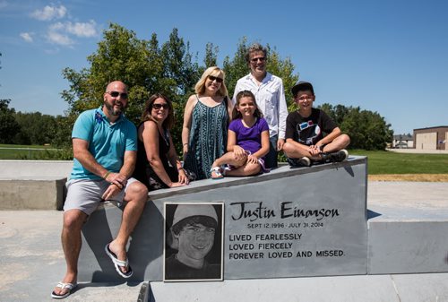 MIKE DEAL / WINNIPEG FREE PRESS The Justin Einarson Memorial Skatepark in Fort Richmond was dedicated by community members, officials from the City of Winnipeg and the Province Sunday afternoon.  Family and friends pose with the engraved memorial at the skatepark, (from left) Chris Chudley, Dana Chudley, Joan Durrant, Greg Olsen, Cassie Olsen, 9, and Rylen Olsen, 12. 160807 - Sunday, August 07, 2016