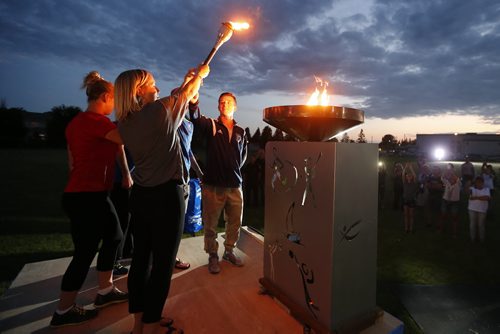 JOHN WOODS / WINNIPEG FREE PRESS Michelle Sawatzky Koop lights the caldron at the opening ceremonies of the Manitoba Games in Steinbach, Sunday, August 7, 2016.
