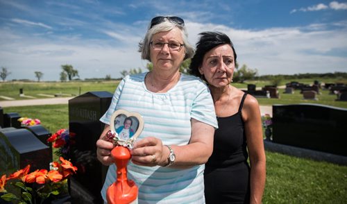 MIKE DEAL / WINNIPEG FREE PRESS Sisters, June Feakes (left) holding a photo of their mother and Brenda Winning Jensen (right) at the plot site of their mother Nellie Yosyk who died in February and whose pre-paid tombstone is nowhere to be found. 160808 - Monday, August 08, 2016
