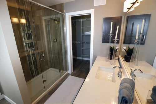 WAYNE GLOWACKI / WINNIPEG FREE PRESS    Homes. The bathroom off of the master bedroom. At left, is the shower with walk in closet at back in the house at 48 East Plains Drive in Sage Creek. The  Qualico Homesrep. is  Courtney Sims.     Todd Lewys story August 8 2016