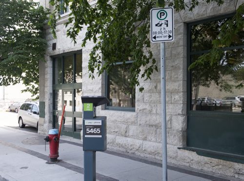 ZACHARY PRONG / WINNIPEG FREE PRESS  Despite the sign on the right indicating paid parking is allowed in this location on Market Ave., anyone who parks here will be ticketed for parking to close to a fire hydrant. August 8, 2016.