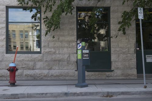 ZACHARY PRONG / WINNIPEG FREE PRESS  Despite the sign on the right indicating paid parking is allowed in this location on Market Ave., anyone who parks here will be ticketed for parking to close to a fire hydrant. August 8, 2016.