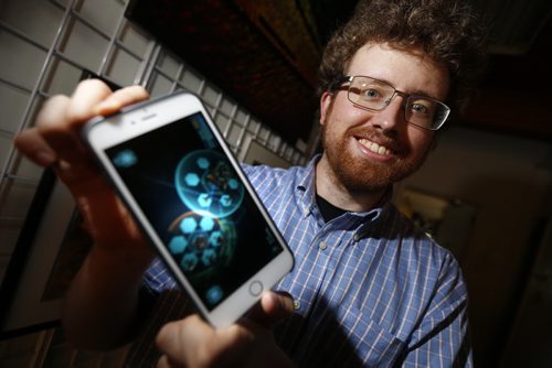 JOHN WOODS / WINNIPEG FREE PRESS Corey King of ZenFri Inc. a creator of the augmented reality game Clandestine: Anomaly, which is available on mobile devices, shows his game at Coronation Park, Monday, August 8, 2016. The game came out a year prior to Pokemon Go's release, and they were working with the technology four years prior to that. They are hoping Pokemon Go will spark a new interest in augmented reality games.