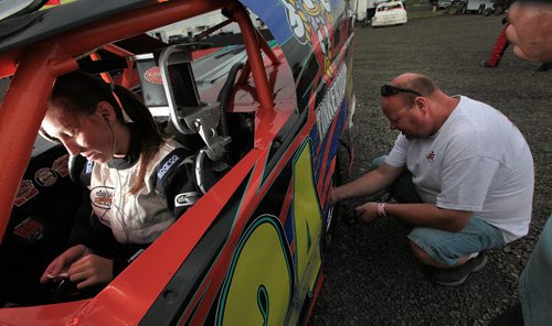 PHIL HOSSACK / WINNIPEG FREE PRESS - Victoria Stutsky checks the details in the cockpit, while dad Rob Stutsky cyecks tire pressure at Red River Speedway turn Monday evning. See Dave Sanderson story.  See story. August 8, 2016