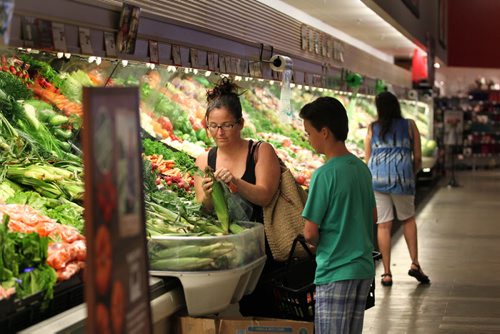 RUTH BONNEVILLE / WINNIPEG FREE PRESS  Tracy Fish and her son Maclean buy produce at the Coop Food store on Grant Ave. Tuesday afternoon.  For Kristin Annable story about Sunday shopping hours.  Aug 09, 2016