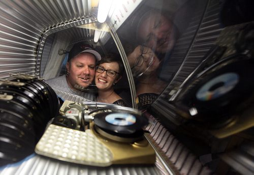 PHIL HOSSACK / WINNIPEG FREE PRESS - Eric and Angela Swanson gaze into the interior of vintage Rockola Jukebox in their bedroom. They've have been collecting pinball machines and arcade memoribilia for years. See Dave Sanderson story. August 8, 2016