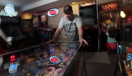 PHIL HOSSACK / WINNIPEG FREE PRESS -  Eric Swanson gets lost in his favorite pinball machine a collector's dream the "Twighlight Zone" named after the 1960's TV show. He's been collecting pinball machines and arcade memoribilia for years. See Dave Sanderson story. August 8, 2016