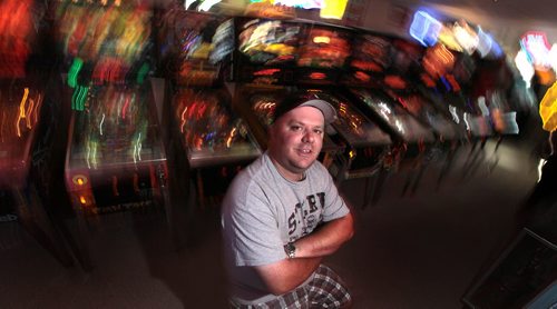 PHIL HOSSACK / WINNIPEG FREE PRESS - Pinball Wizzard, Eric Swanson poses in his Selkirk area basement with some of the pinball machines he's collected to turn his basement into an arcade. See Dave Sanderson story. August 8, 2016